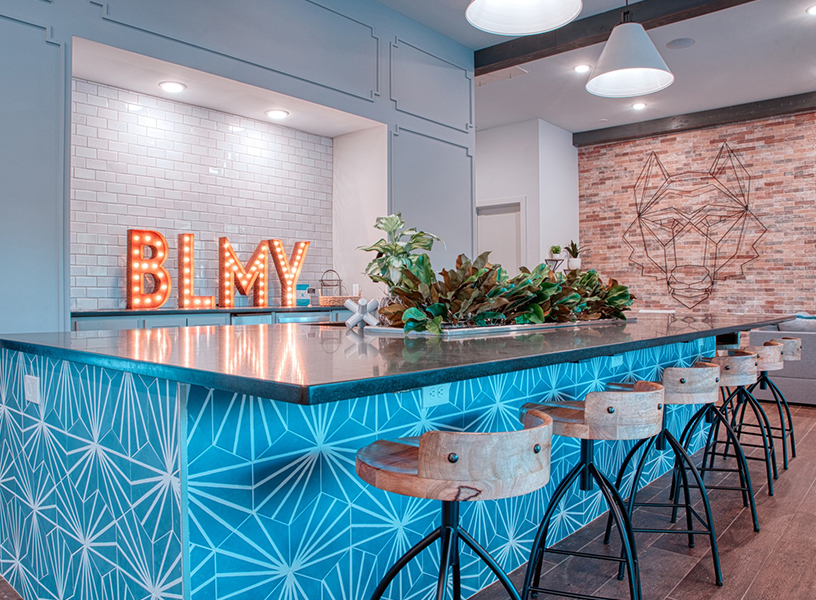 Bar stools next to Bright sign